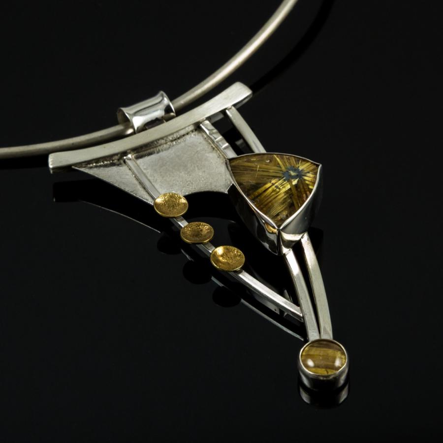 Silver necklace with geometric design and amber stones.