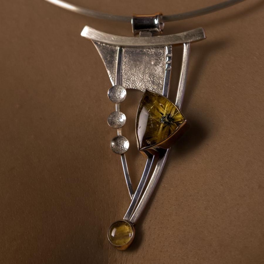 Woman wearing a silver pendant necklace.