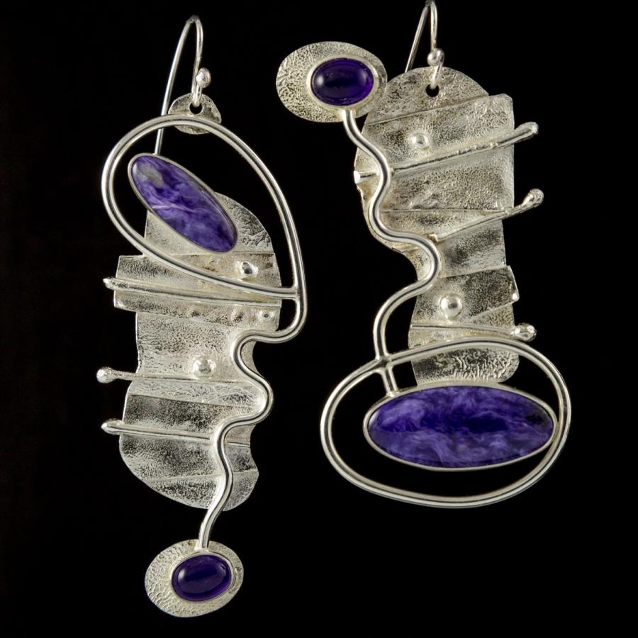 Two silver and purple artistic earrings.