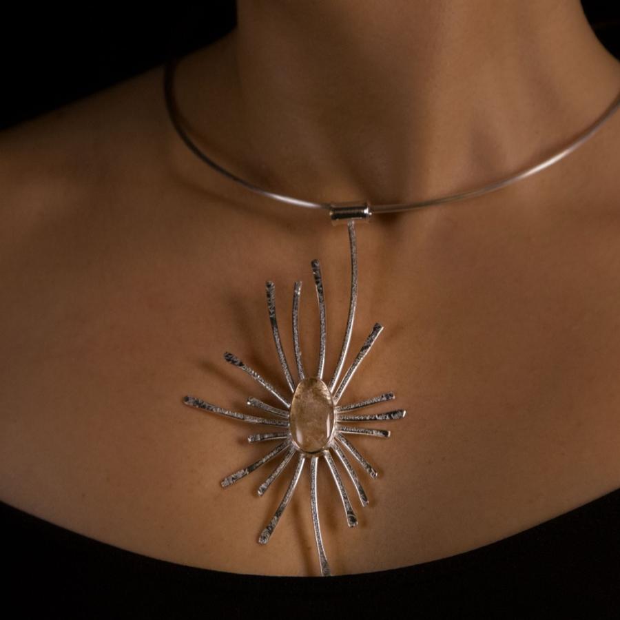 Woman wearing a starburst necklace.