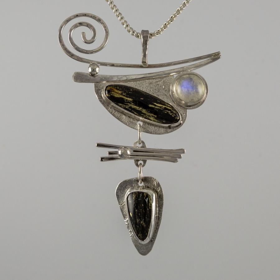 Abstract pendant necklace, jewelry photograph.