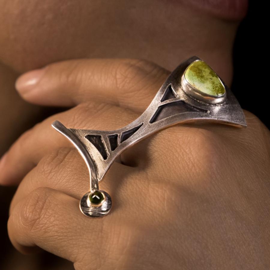 Close-up of a woman's hand with jewelry.