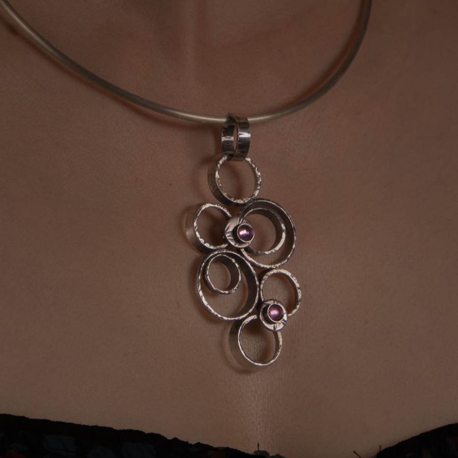 Woman wearing silver necklace.