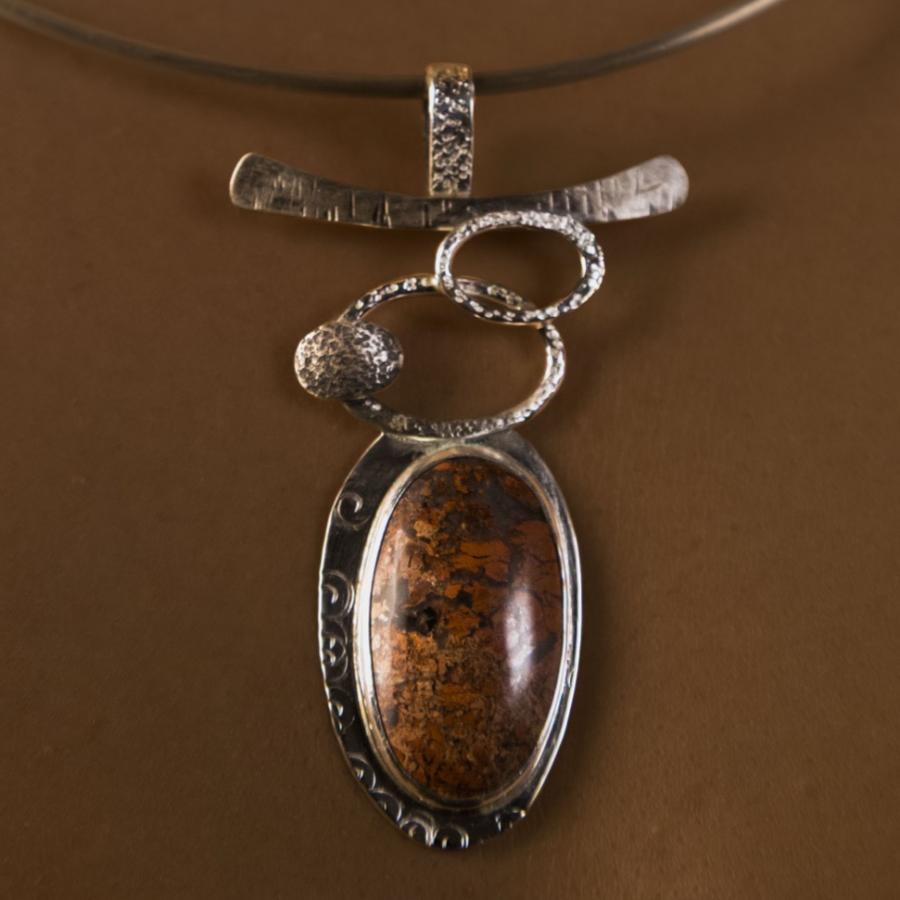 Necklace with silver accents and red stone.