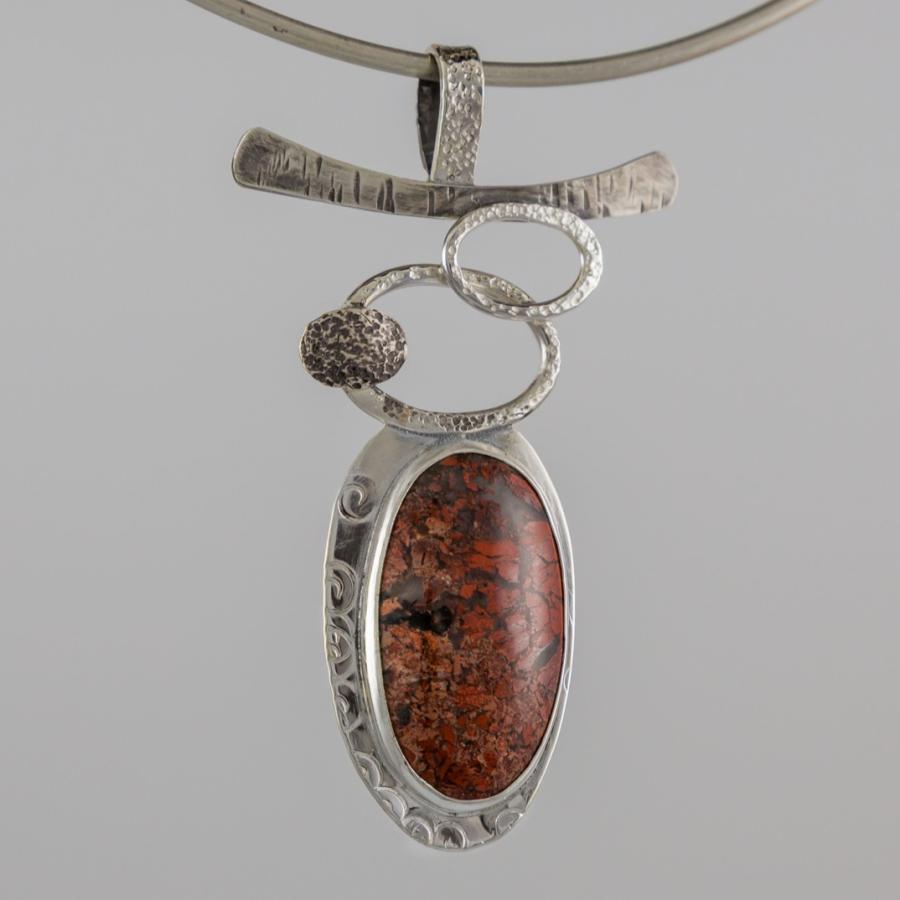 Photograph of a silver pendant necklace.