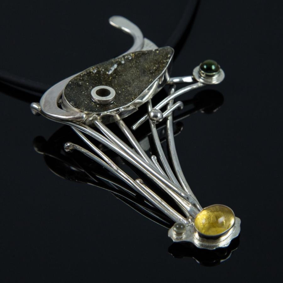 Silver pendant with green and yellow stones.