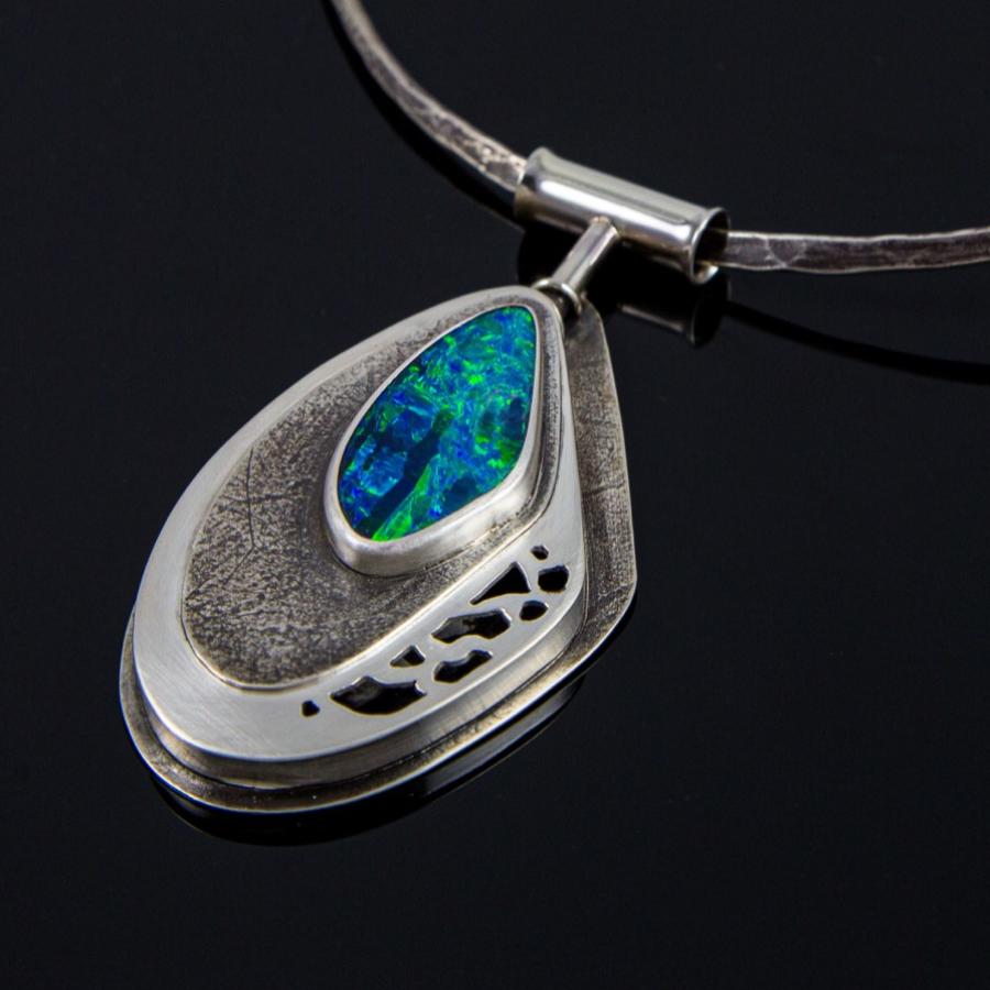 Silver necklace with blue-green opal pendant, photograph.