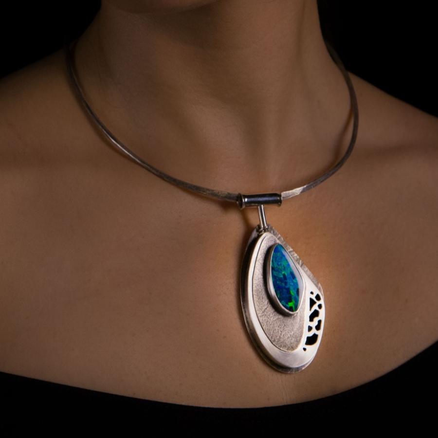 Woman with a teardrop pendant necklace, photograph.