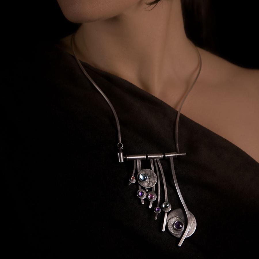 Woman wearing a silver handmade necklace.