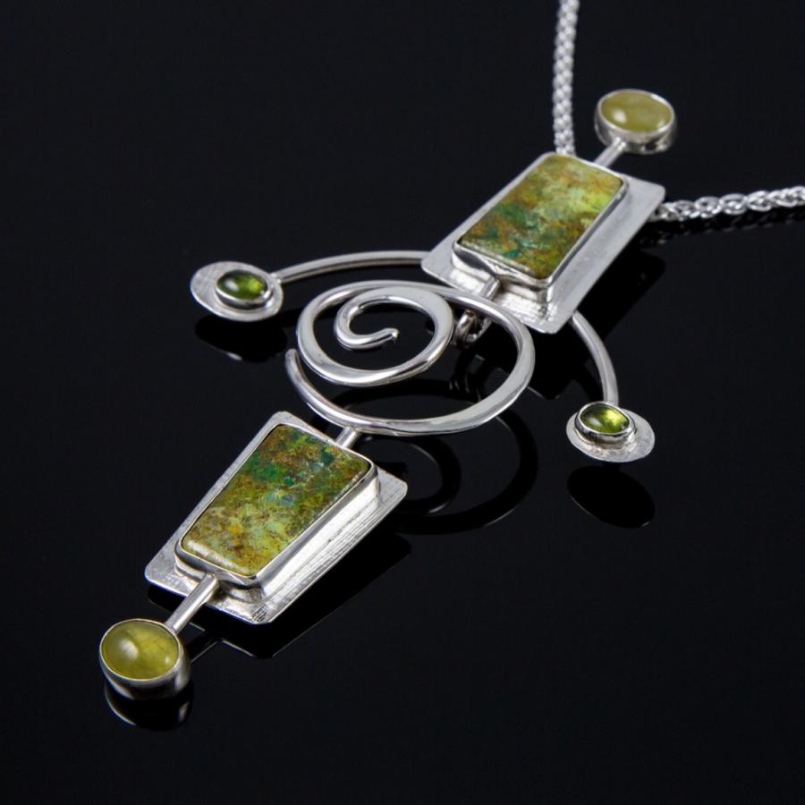 Silver necklace with green stone pendants, photograph.