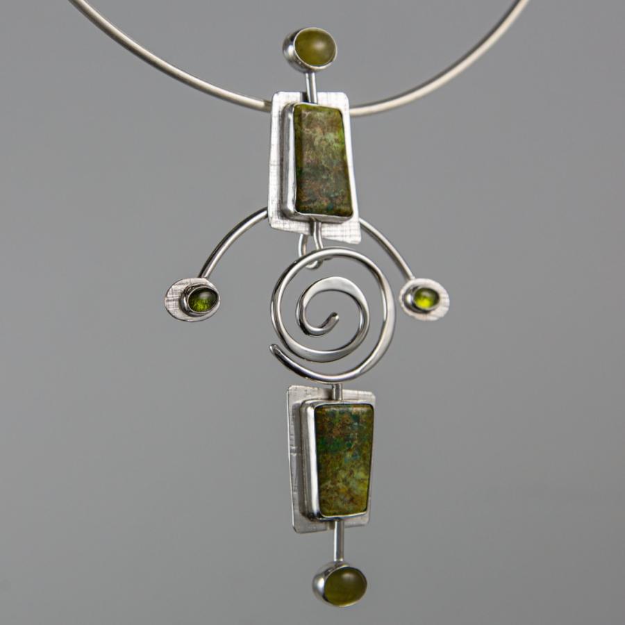 Necklace pendant with green stones, silver coil.