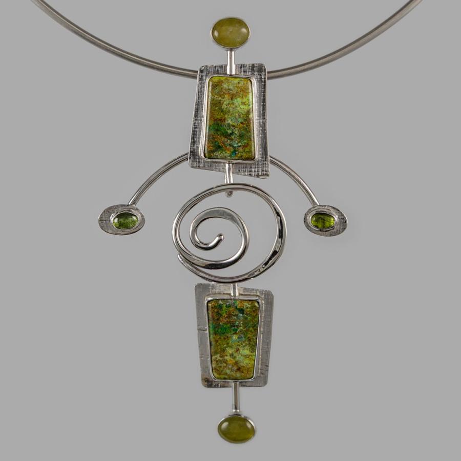 Silver necklace with green rectangular stones.