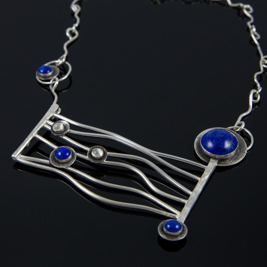 Silver necklace with blue stones, photograph.