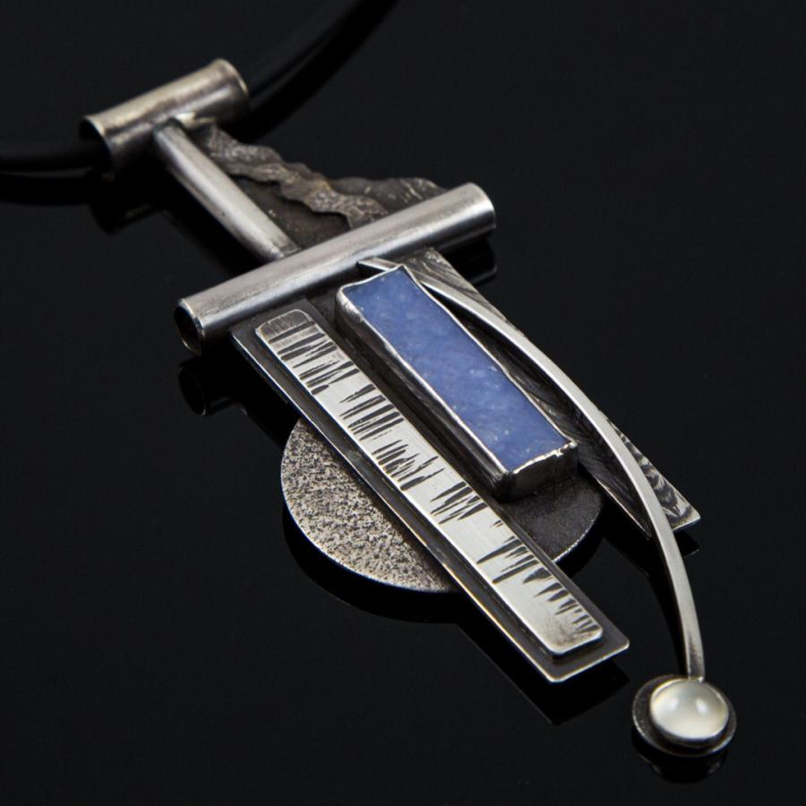 Modern silver necklace with blue stone.