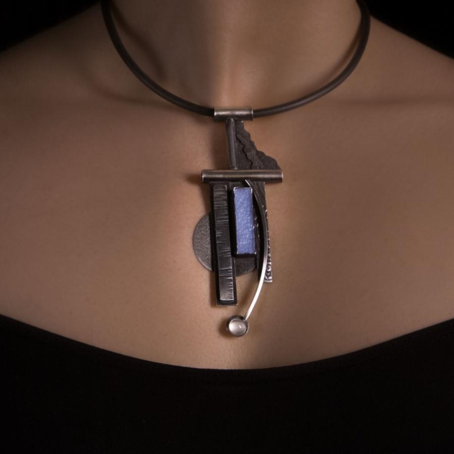 Woman wearing a unique pendant necklace.
