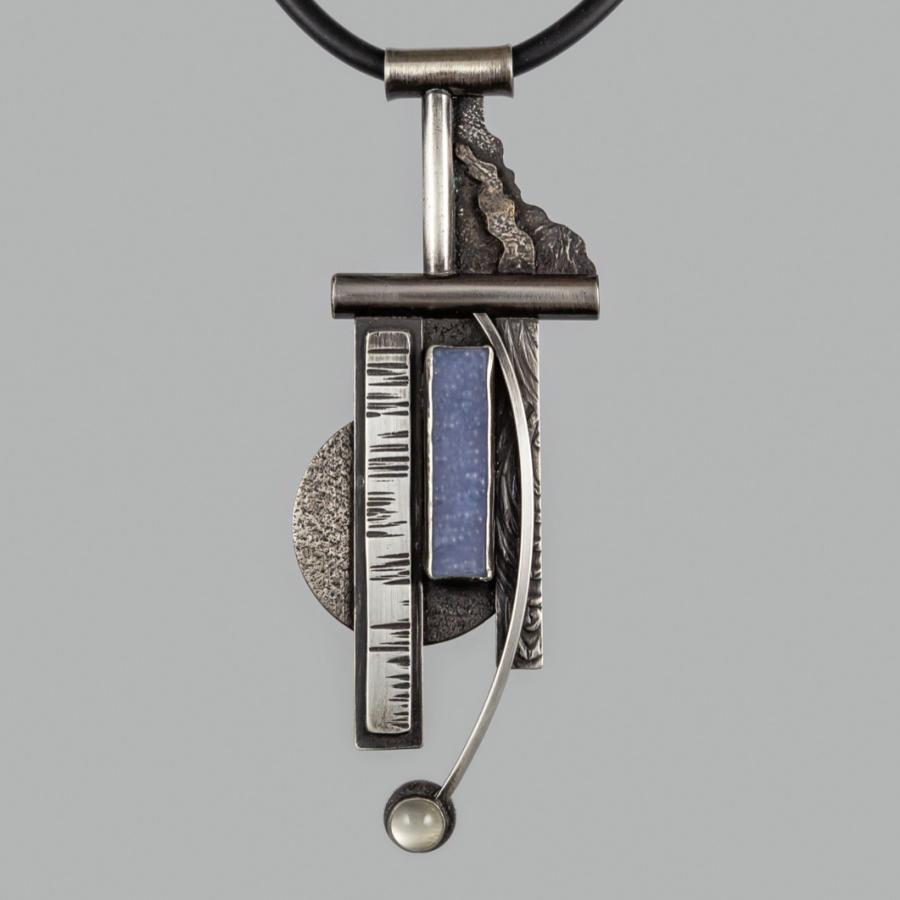 Silver necklace with geometric designs.