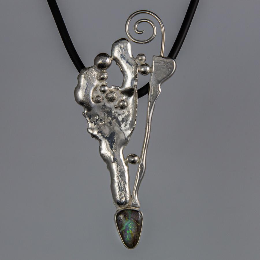 Silver pendant with black cord.