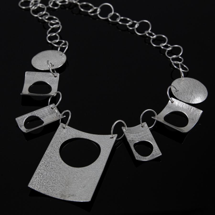 Silver chain necklace with geometric pendants.