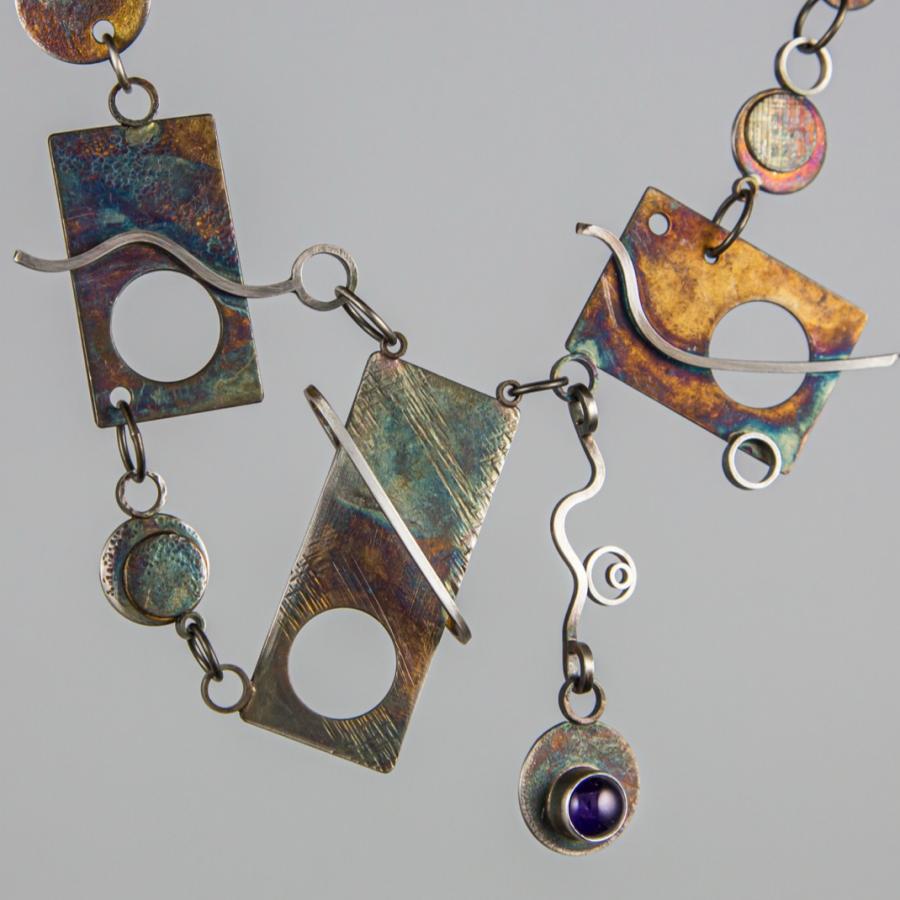 Handmade metal necklace, close-up.