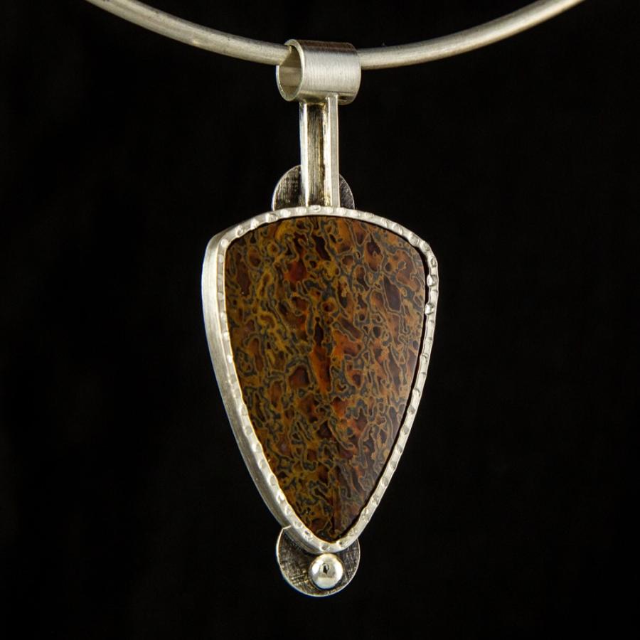 Silver pendant with a mottled brown stone