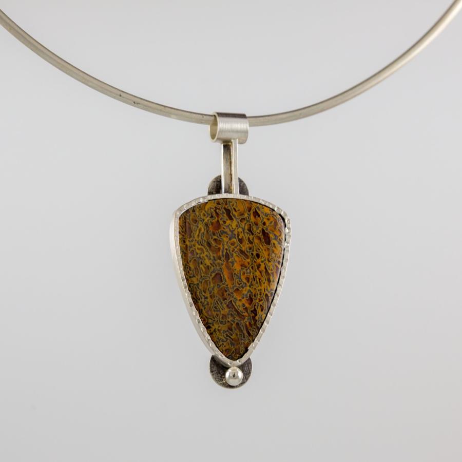 Silver pendant with a mottled brown stone