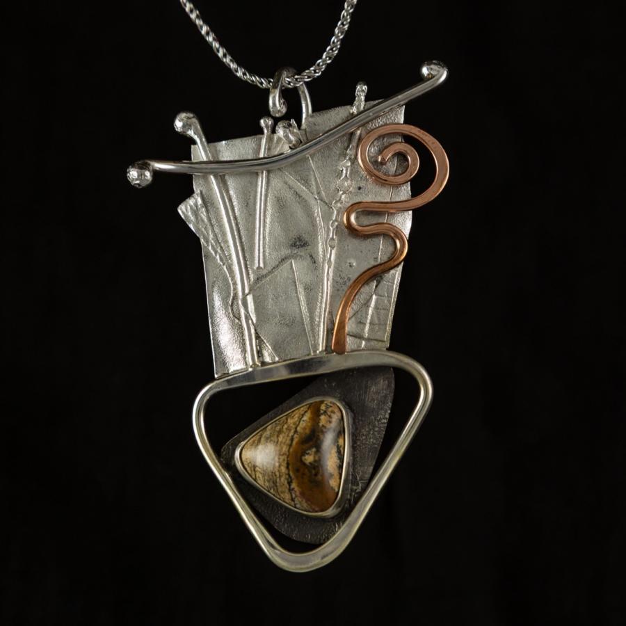Silver and copper pendant with brown stone
