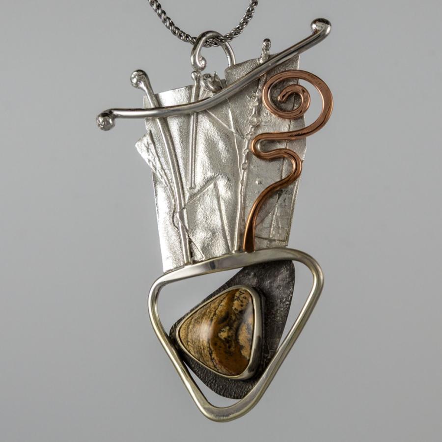Silver and copper pendant with brown stone