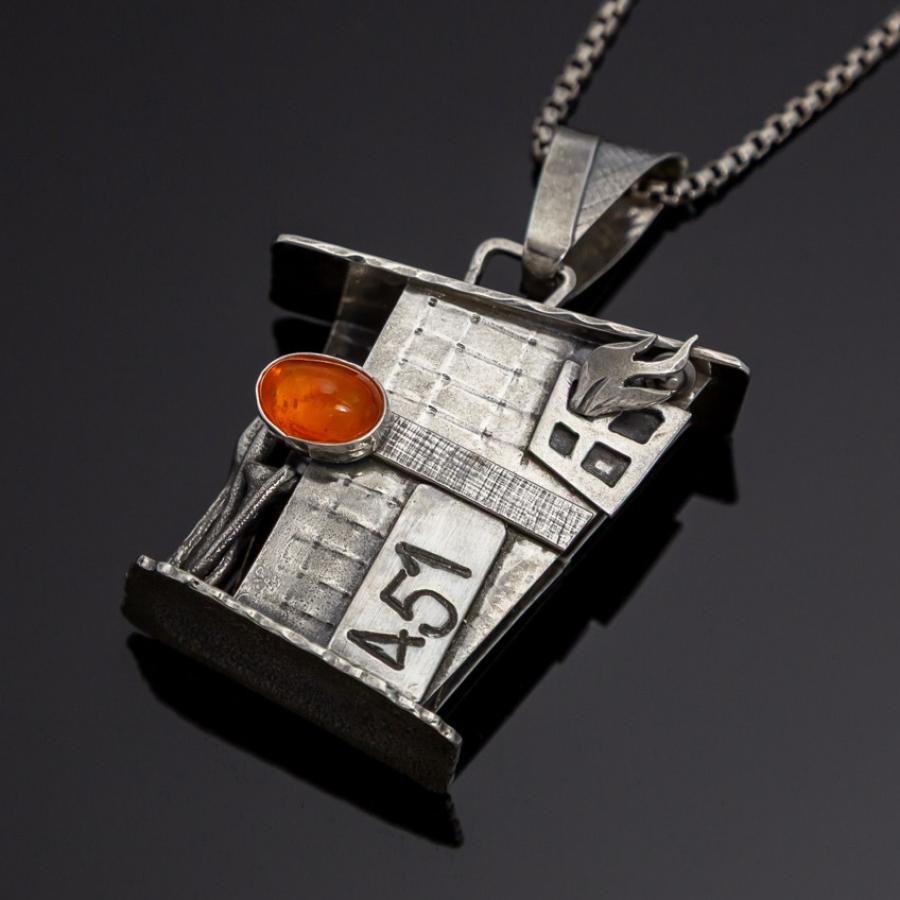 Silver building pendant with orange stone