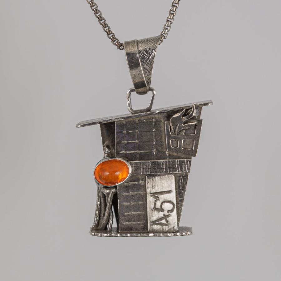 Silver building pendant with orange stone