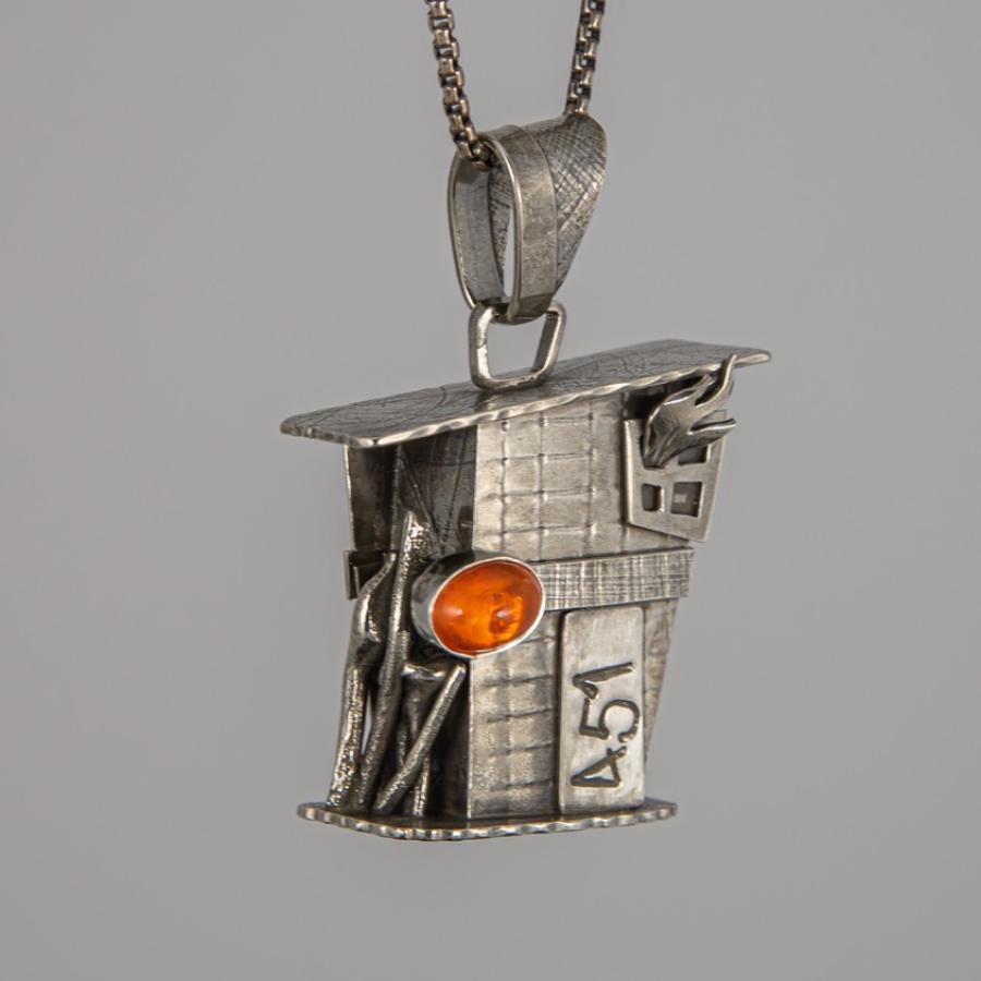 Silver building pendant with orange stone