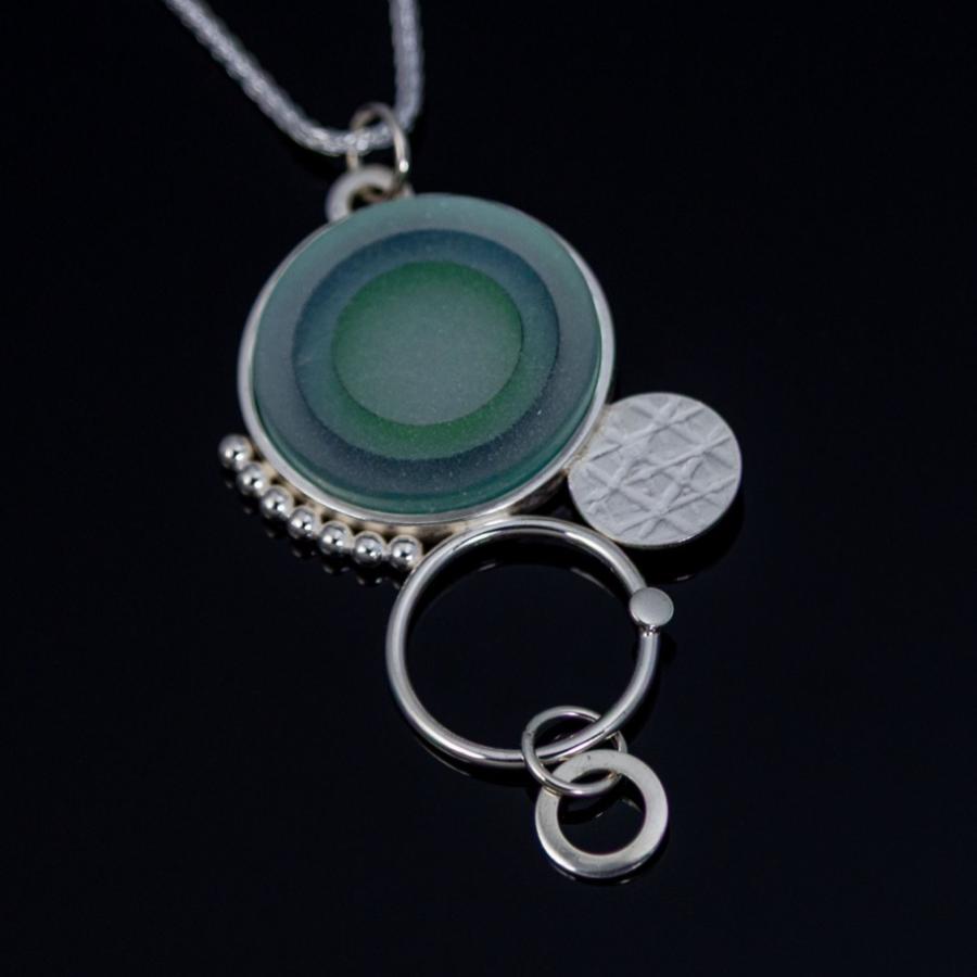 Silver pendant with green glass
