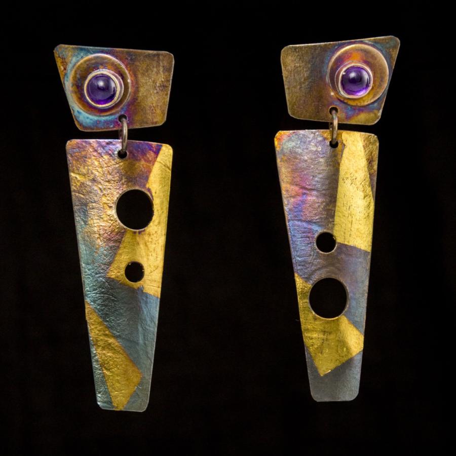 Multi colored earrings with a red stone