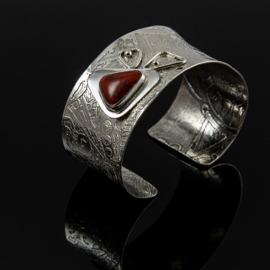 Silver bracelet with a red stone