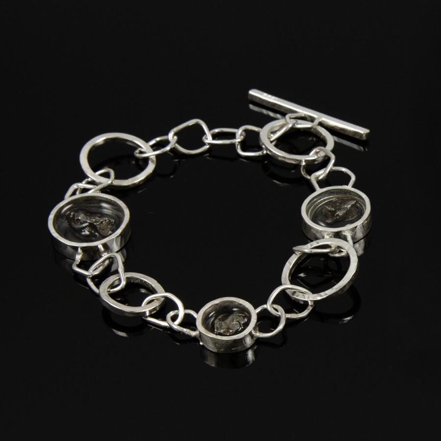 Silver bracelet with circular links and black stones