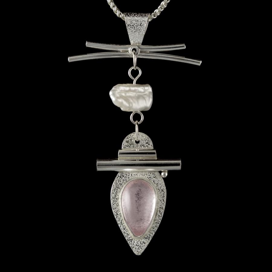 Silver pendant with a pink stone and pearl.