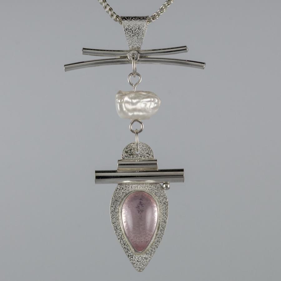 Silver pendant with a pink stone and pearl.