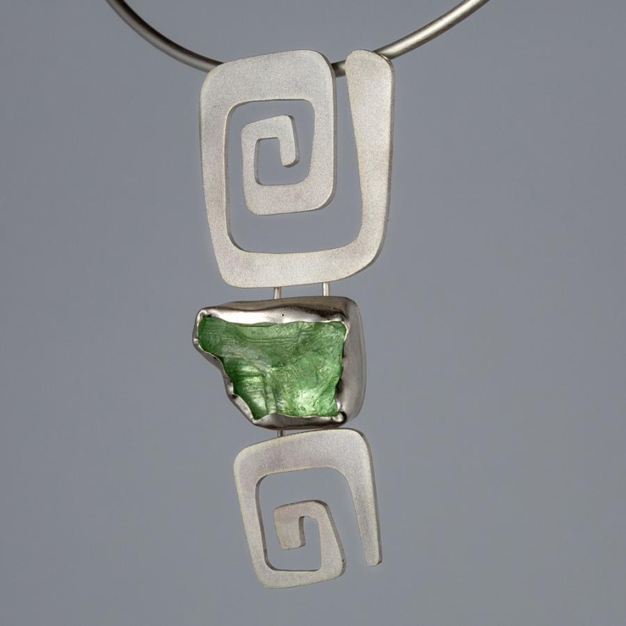Silver pendant with a rough green stone
