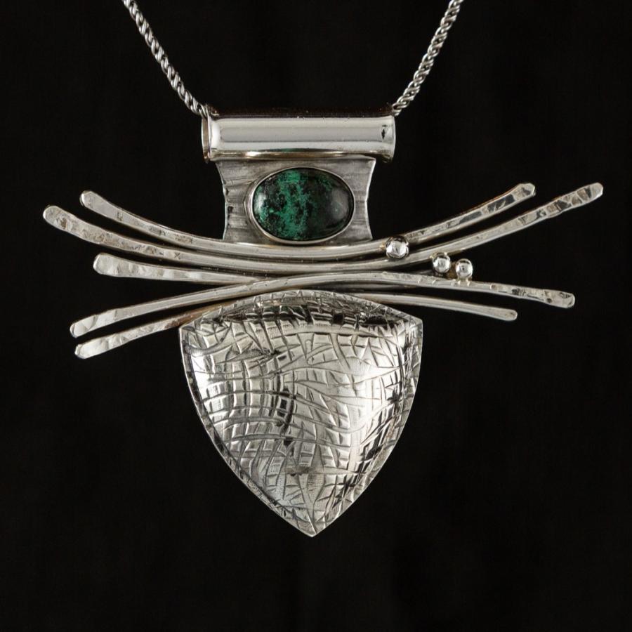 Silver pendant with a green and black stone