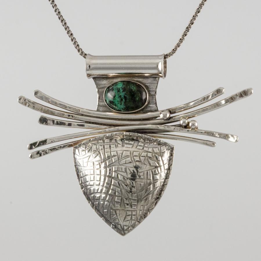 Silver pendant with a green and black stone