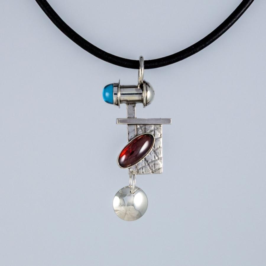 Silver pendant with red and blue stones