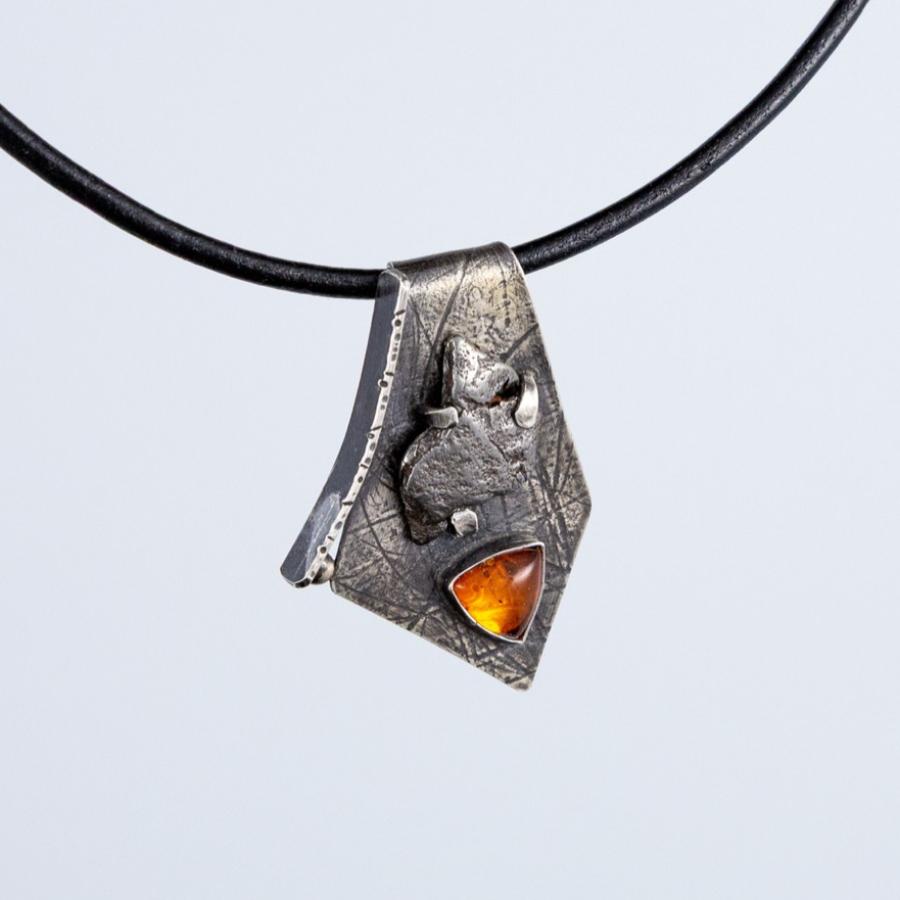 Silver pendant with an orange stone