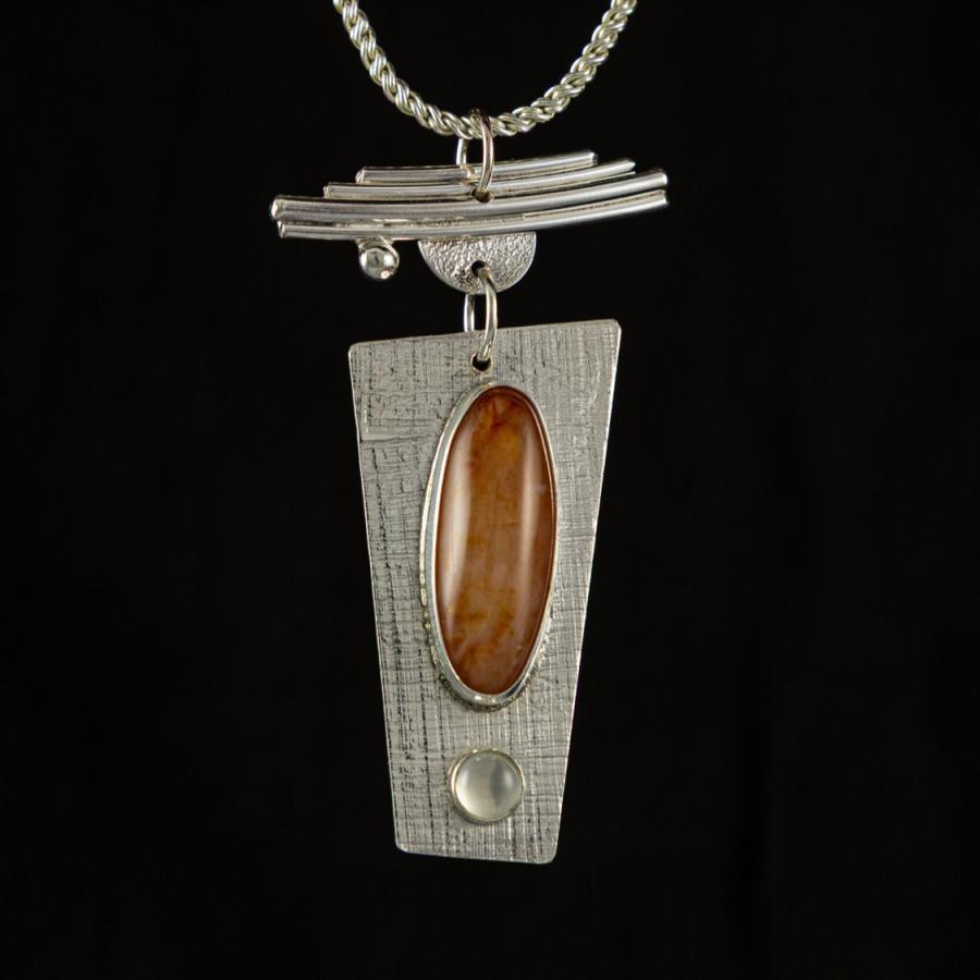 Silver pendant with orange and clear stones