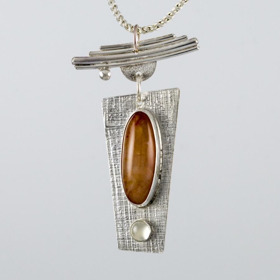 Silver pendant with orange and clear stones