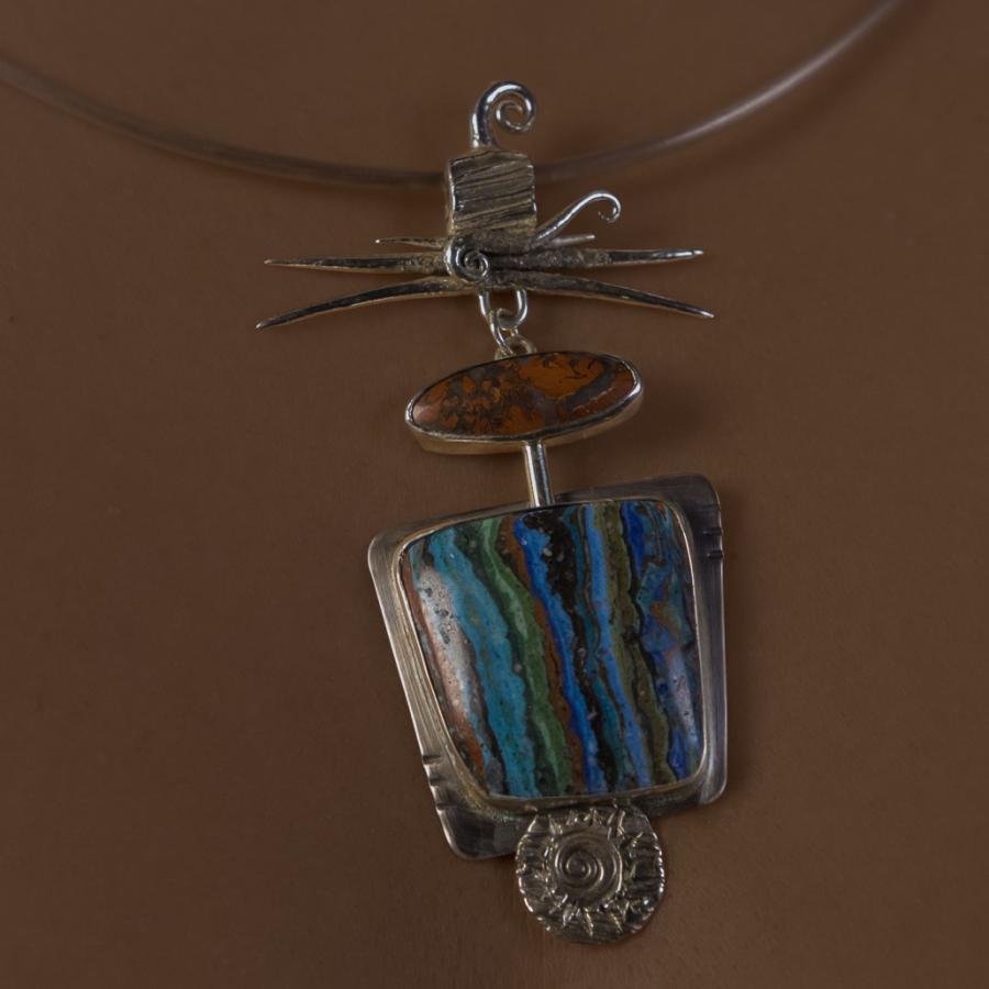 Model wearing a silver pendant with two brightly colored stones