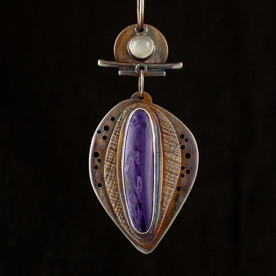 Pendant with a prominent purple stone.