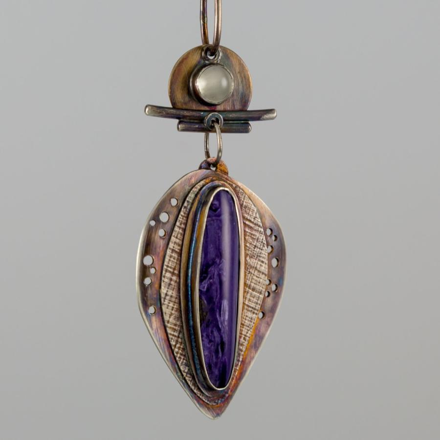 Pendant with a prominent purple stone.