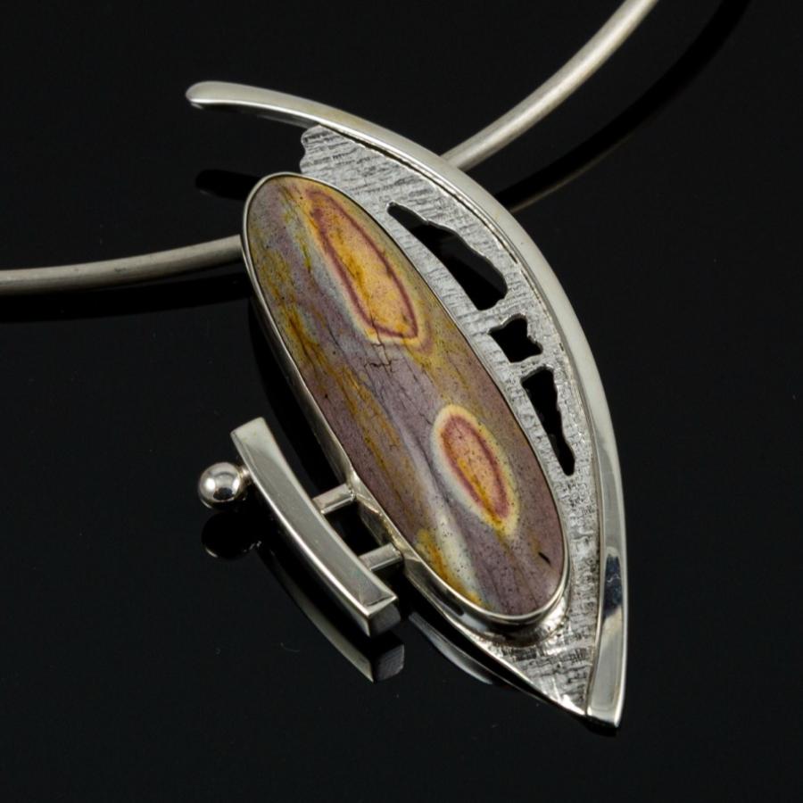 Silver pendant with a long oval multi colored stone