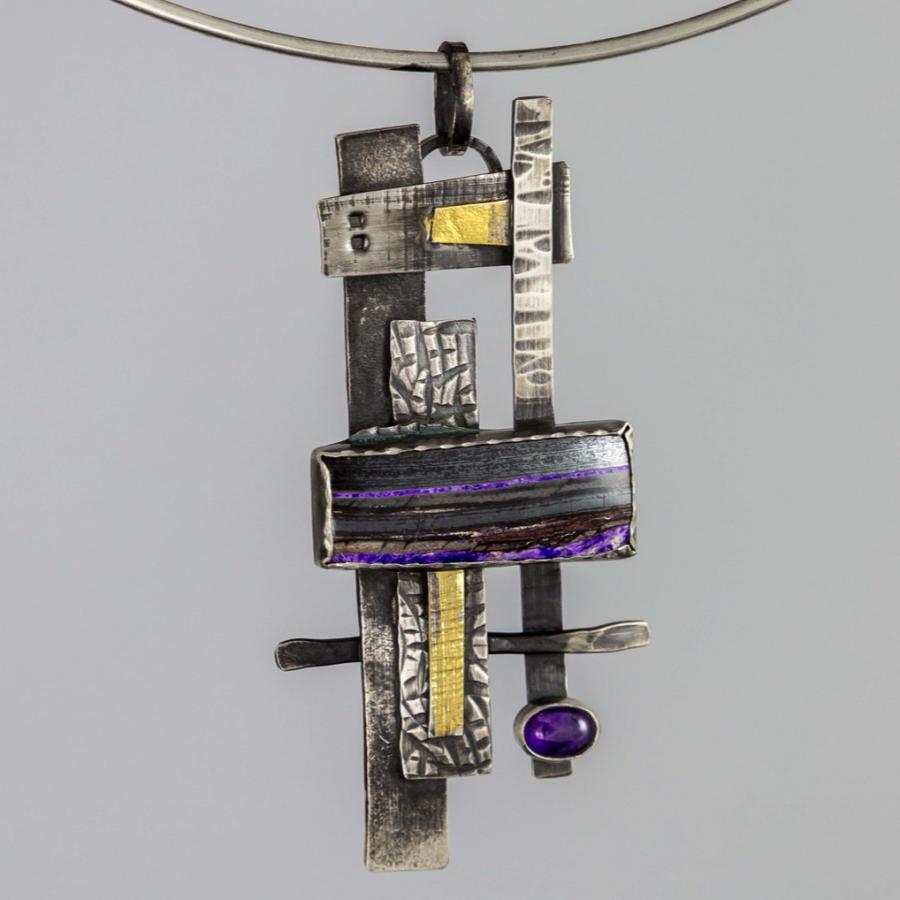 Silver pendant with purple stones and gold accents