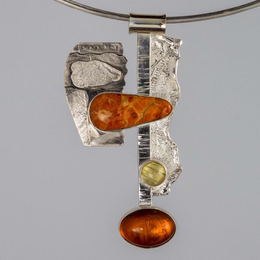 Silver pendant with orange stones