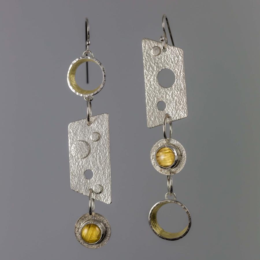 Silver earrings with yellow stones and gold accents